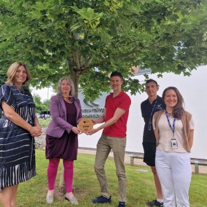 Founder of Planet Earth Games, Chris Broadbent presents the Planet Earth Games trophy to DCG CEO Mandie Stravino alongside DCG deputy CEO Heather Simcox, Sport and Public Services teacher Phil Kilpatrick and DCG environmental and sustainability officer Rachael Willshaw.
