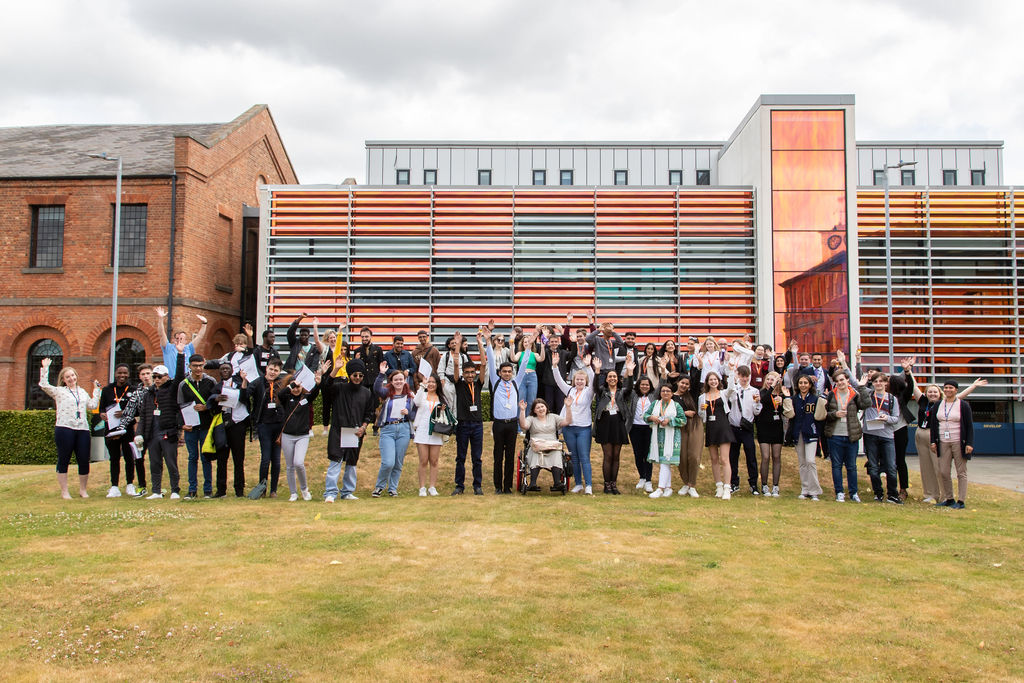 Business students jumping in the air at the Roundhouse College