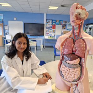 A-level student Rabina Bulakoti sat in a science lab.