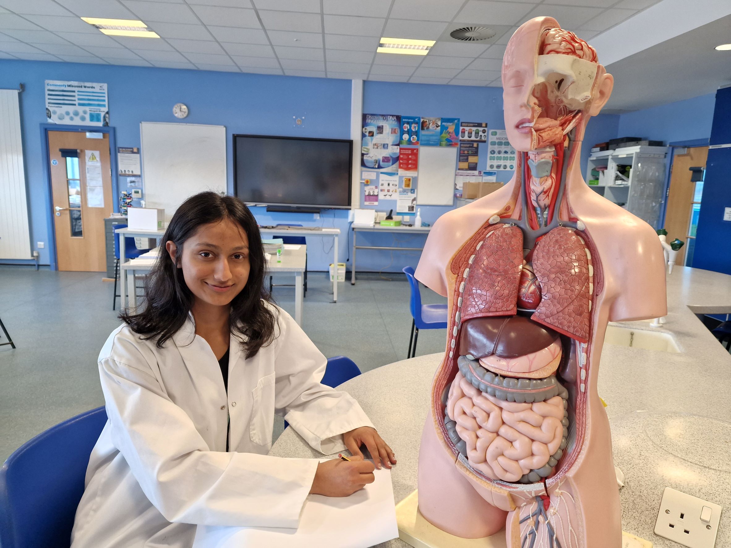 A-level student Rabina Bulakoti sat in a science lab.