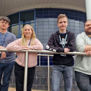 Daniel Ash with support worker Ben Kendall and Games Development teachers Leigh Champion and Nathan Rogers.