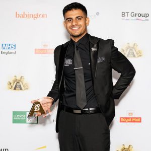 Former Derby College apprentice Ali Amin holding his award.