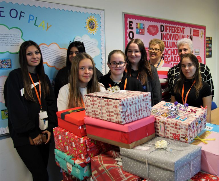 Childcare students stood by their gift boxes.