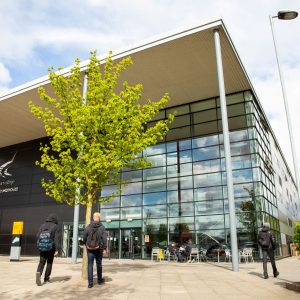 Students walking outside of the Roundhouse where exams will take place