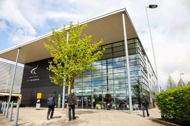 Students walking outside of the Roundhouse where exams will take place