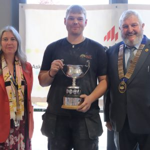 Senior Competition winner and DCG student, Matthew Wooley with DCG CEO Mandie Stravino OBE MBA and The Guild of Bricklayers President Mr Bill Bowmen