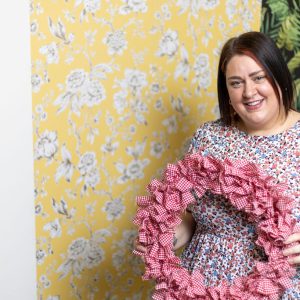 Introduction to Upcycling teacher Laura Smith holding a wreath she created.