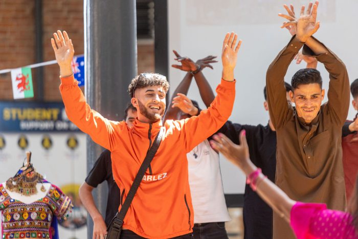 Lexis student smiling whilst dancing.