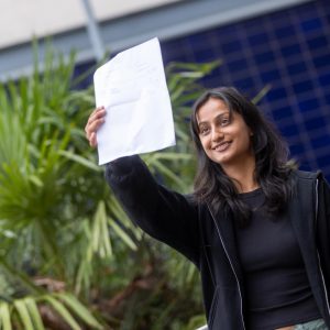 Rabina Burlakoti holding her results.