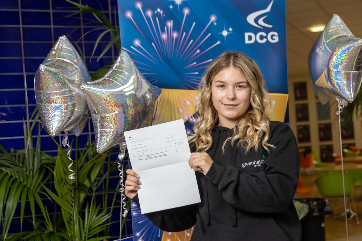 Female student Zuzzana holding her results.