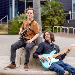 Owen and Dec;and holding their guitars outside of The Joseph Wright Centre.