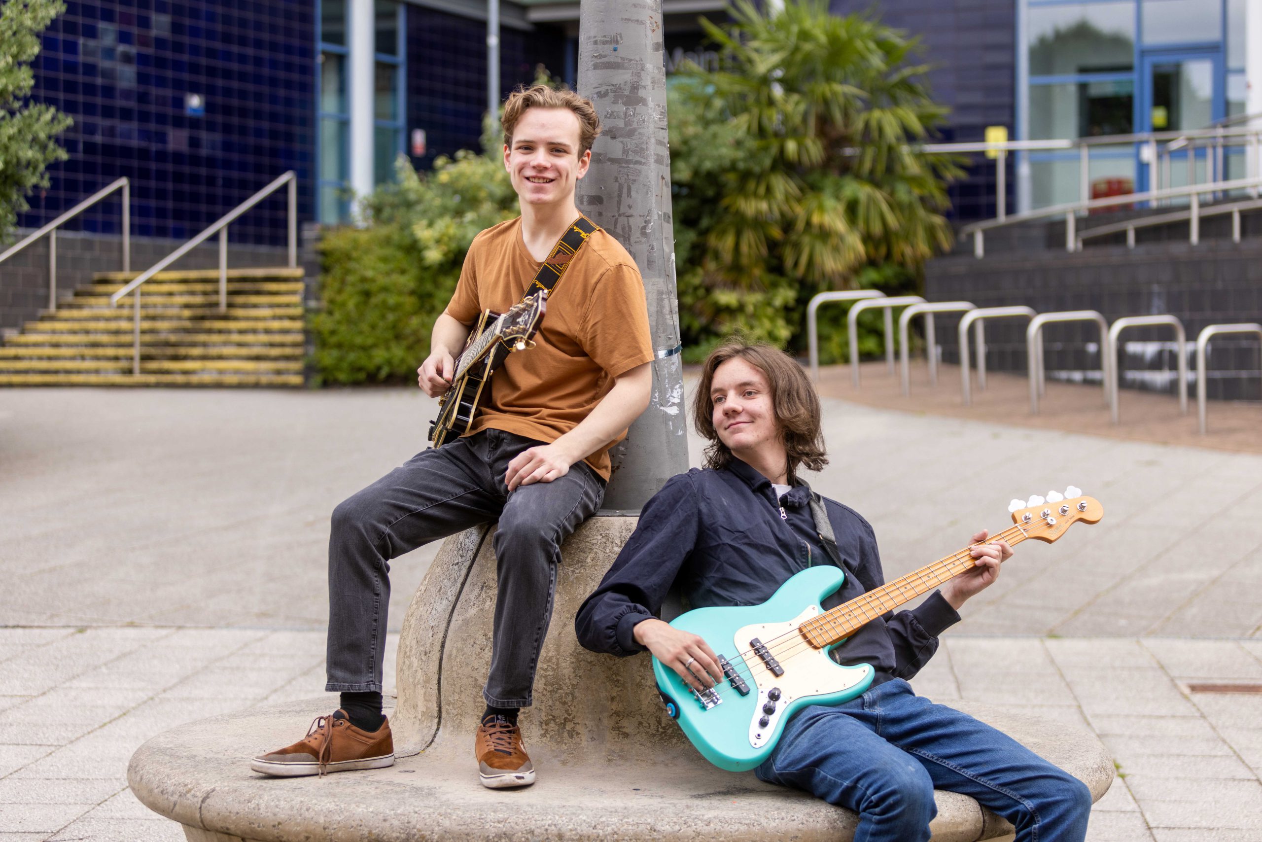Owen and Dec;and holding their guitars outside of The Joseph Wright Centre.