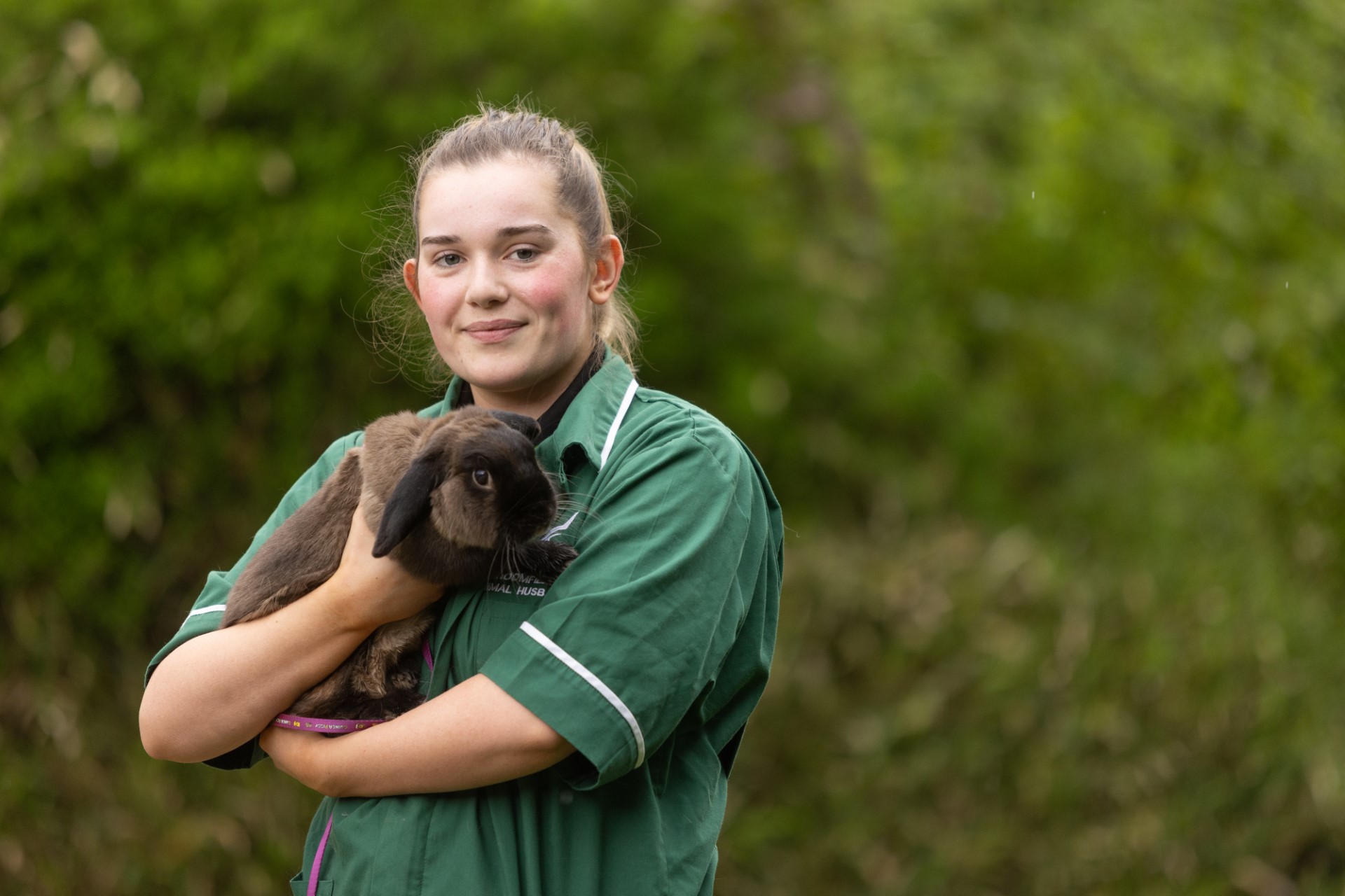 Female student, Liberty Stamp Hanes, holding a rabbit.