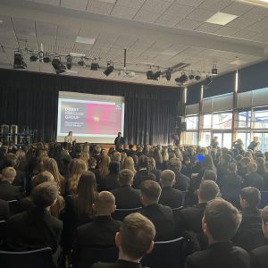 Backs of heads of students watching a presentation at school.