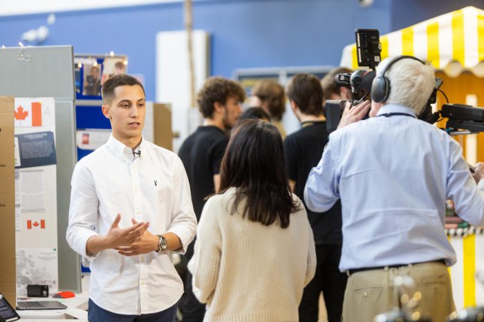 Student talking to a news crew