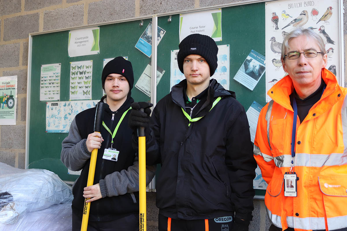 Students with staff member stopped work for photo