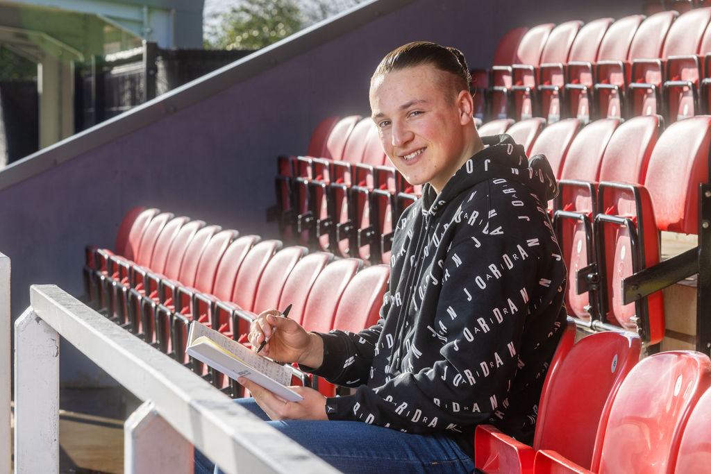 Archie Brown, a former DCG Esports student sat in the stands in a football stadium.