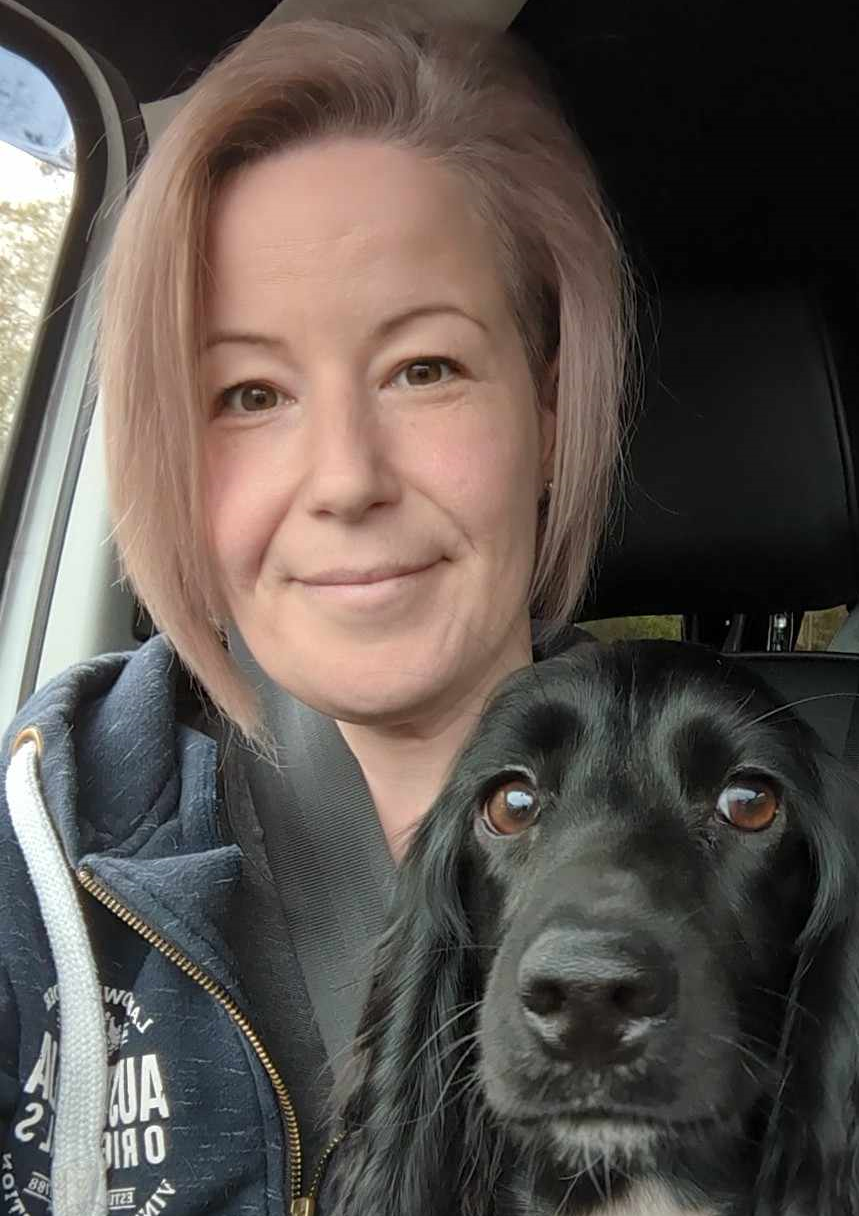 Sarah Lowe, a former DCG Dog Grooming student with her dog, a black cocker spaniel.