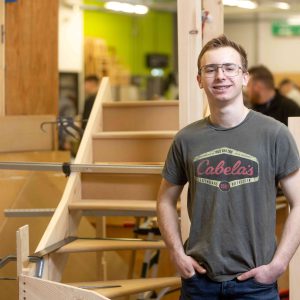 Young apprentice Kai stood in the carpentry workshop.