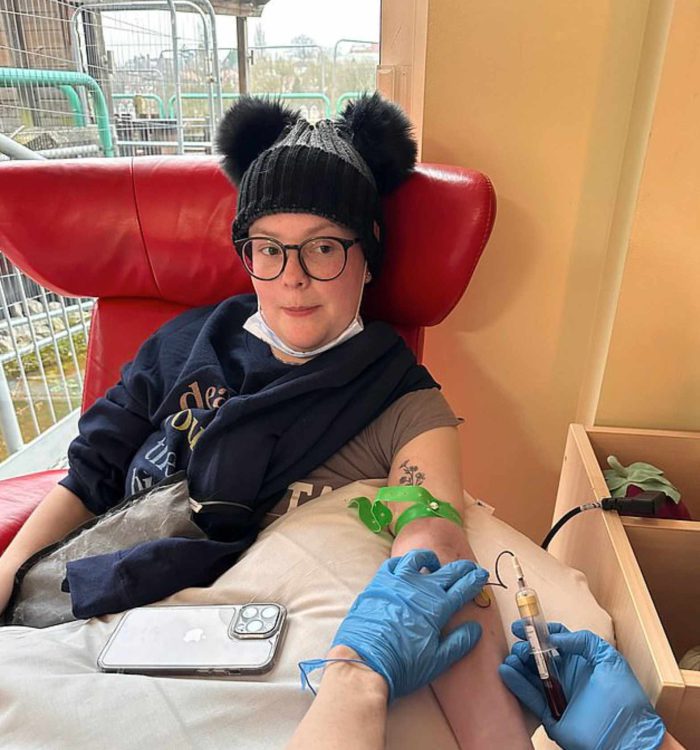 Sally wearing a black bobble hat whilst being treated at hospital.