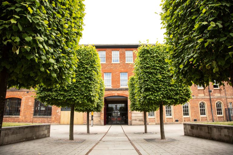 Entrance to the Roundhouse behind some trees.