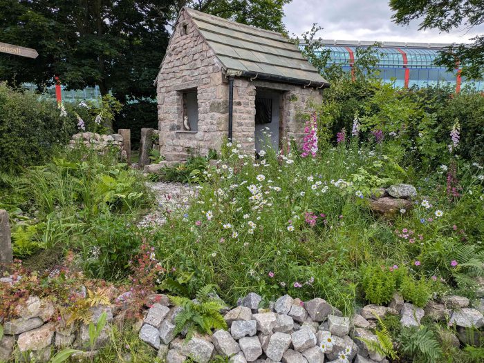 A stone wall outhouse.