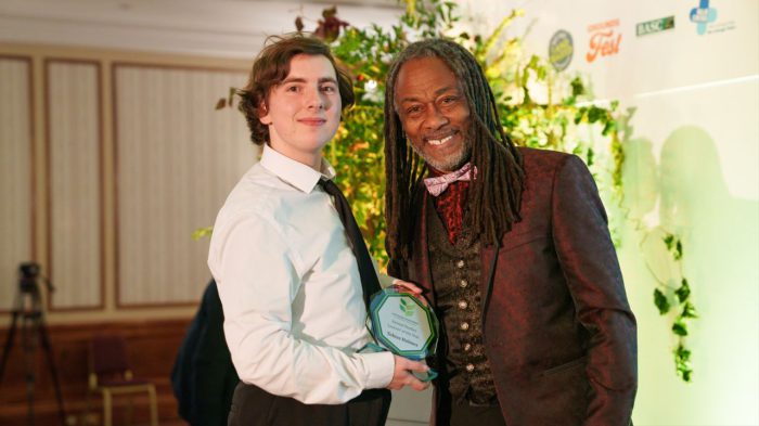 Young student being handed an award.