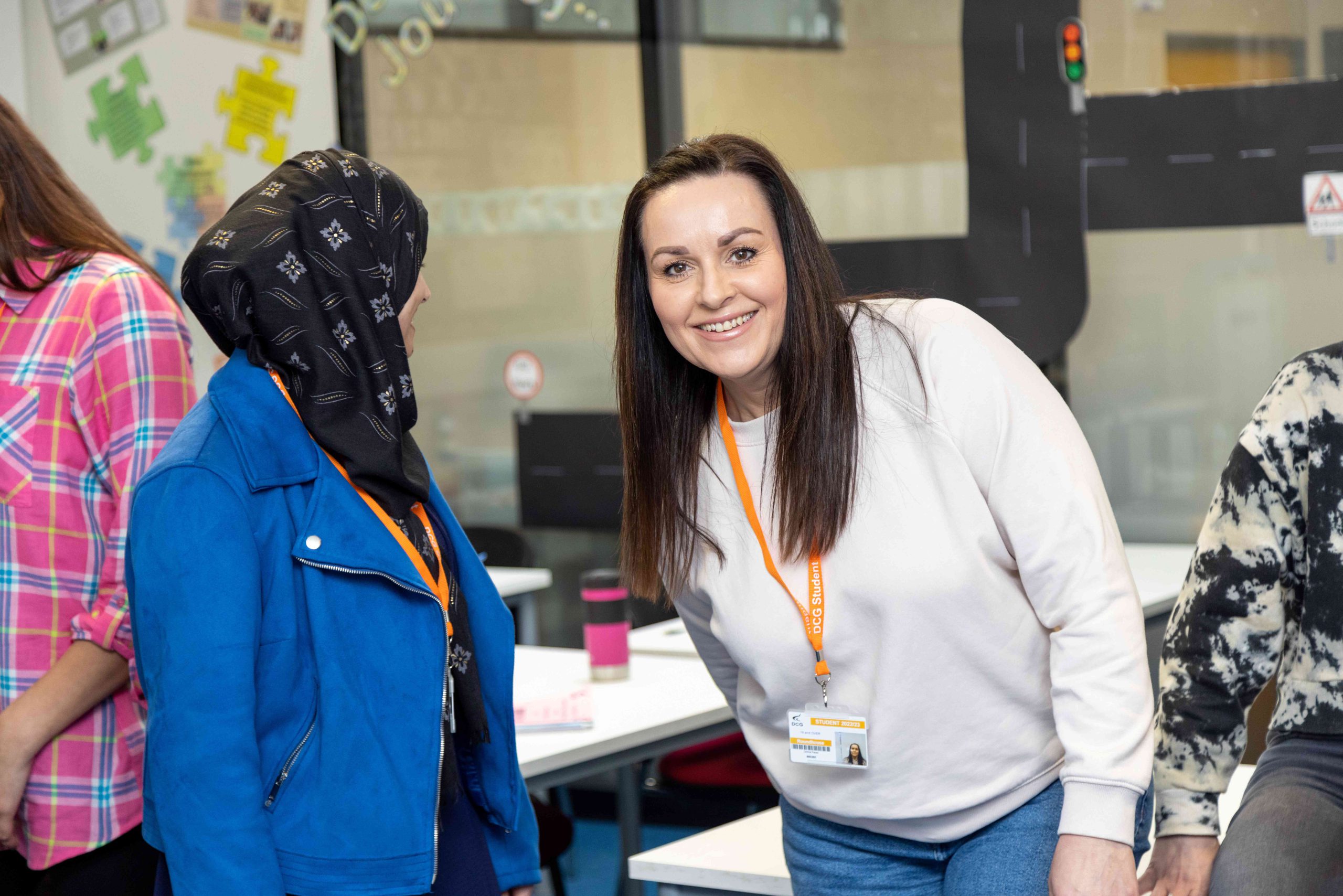 Two teaching apprentices smiling at one another.