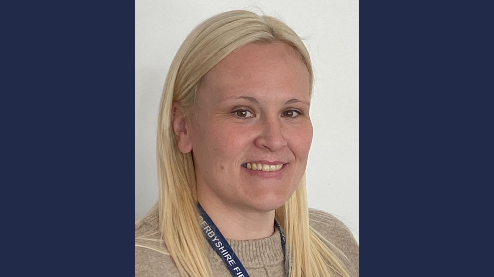 Hayley Crofts, a smiling woman with blonde hair wearing a lanyard.