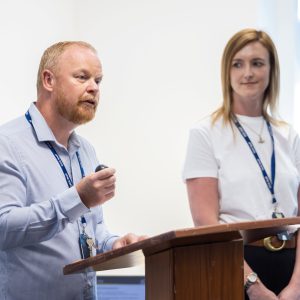 A man addressing an audience at a lectern