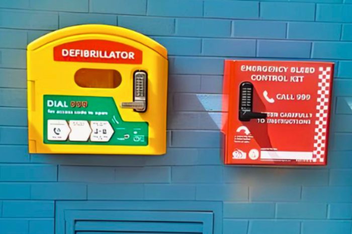 Defibrilator and bleed control kit on a wall.