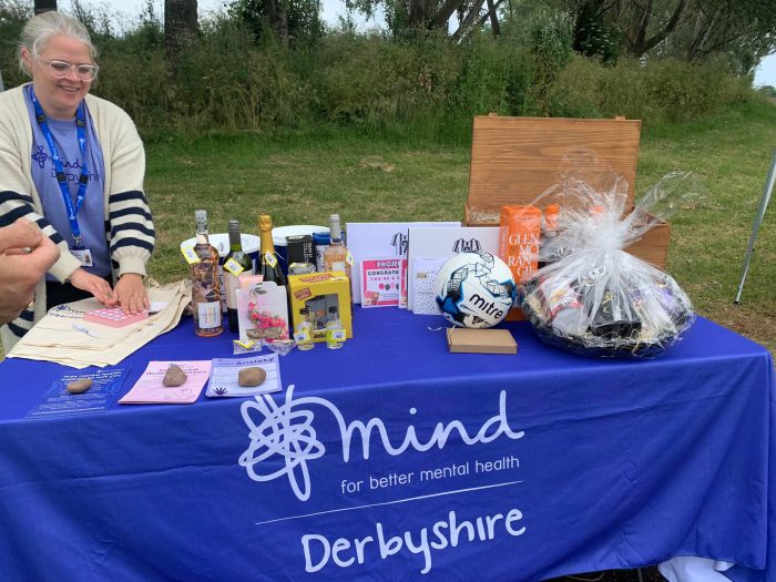 Former DCG apprentice Sarah stood behind a blue stall raising money for charity, selling various goods.