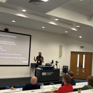 Man with big beard talking an audience in a lecture theatre