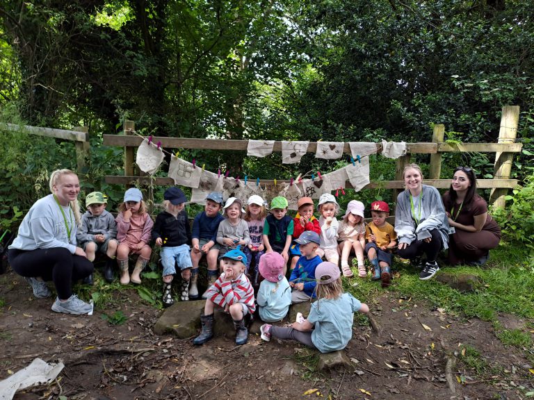 Teachers outside with young children at a nursery