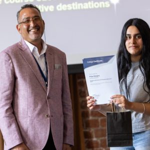 Young T Level student celebrating graduation with her employer.