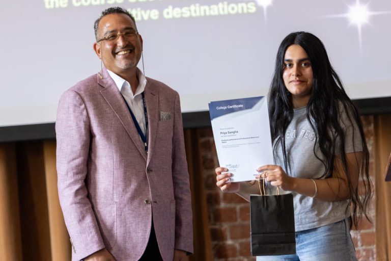 Young T Level student celebrating graduation with her employer.