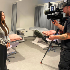 Beauty student talking to a cameraman for the news.
