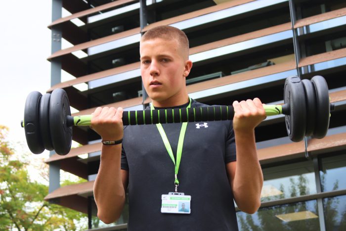 Student at Broomfield Hall doing barbell reps.