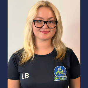 Student with blonde hair and glasses wearing a sports jersey.