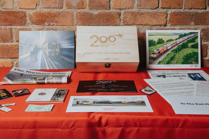 Various documents and other materials included in the time capsule on a table.