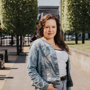 Derby College Group Adult Learning student stood in front of trees at The Roundhouse.
