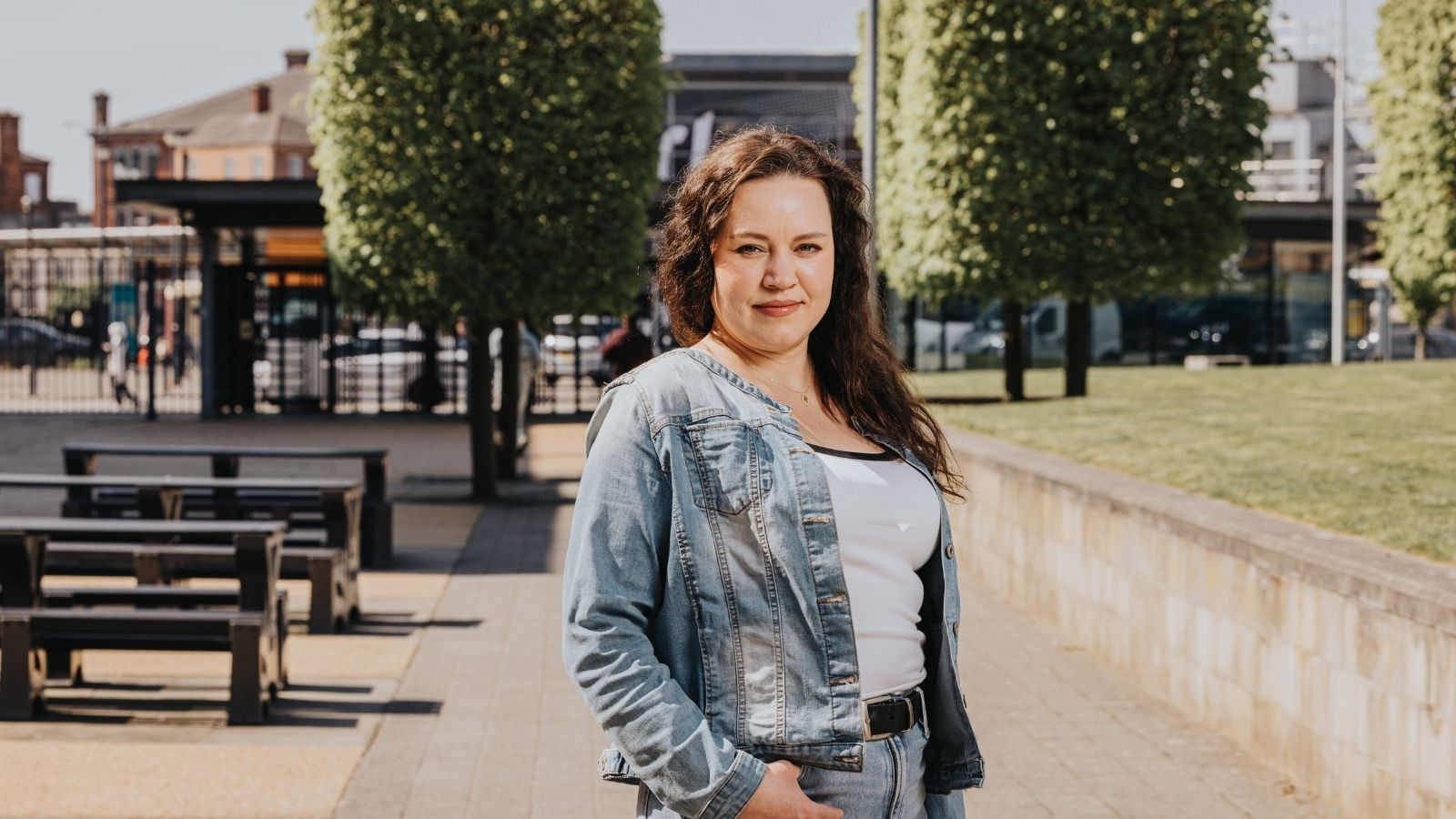 Derby College Group Adult Learning student stood in front of trees at The Roundhouse.