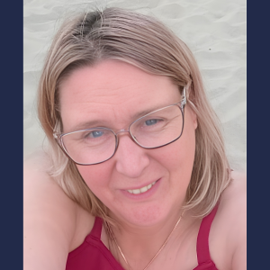 Person with blonde hair, wearing eyeglasses.