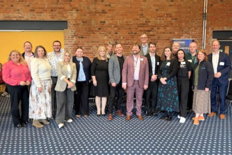 A group of students and local business representatives standing together at the Derby College Group networking event, showcasing employer engagement and real‑world employability skills.