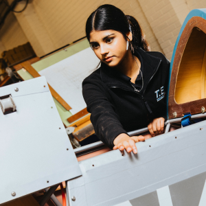 Derby College Engineering T Level student, Hafza, working with engineering tools.