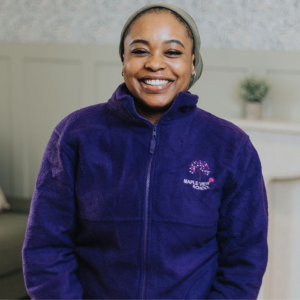 Person wearing a blue jacket in a residential school setting.