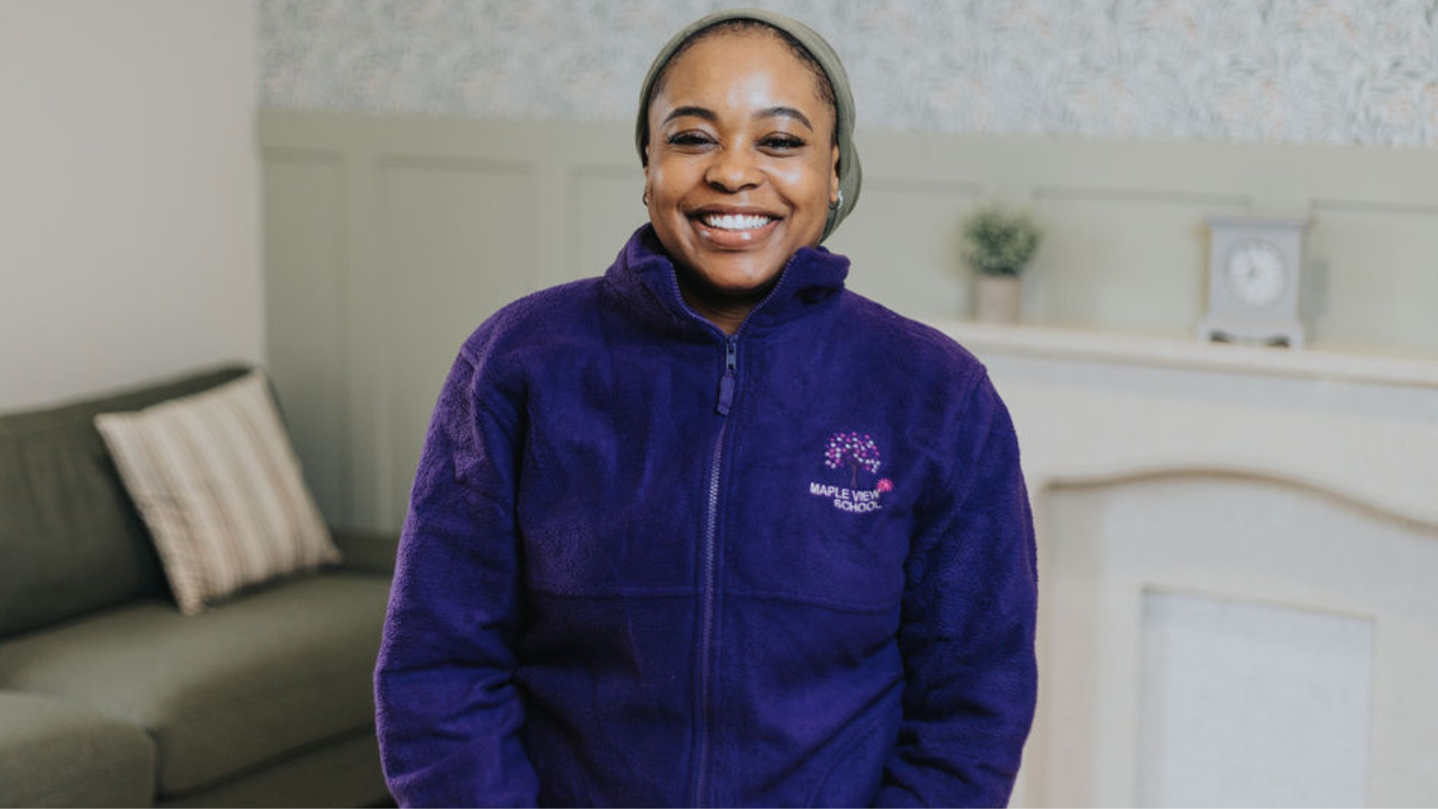 Person wearing a blue jacket in a residential school setting.