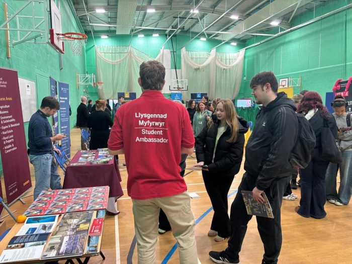 Students networking with universities at a higher education insight event, exploring university level courses including animal care, equine and land-based programmes and vocational pathways through higher education.