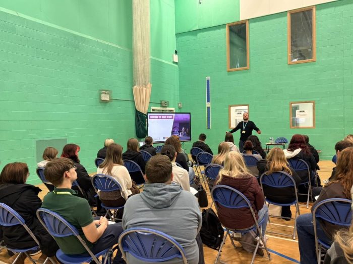 Students seated at a higher education insight event presentation, learning about university level courses and progression routes into higher education, including animal care, equine studies and land-based subjects.