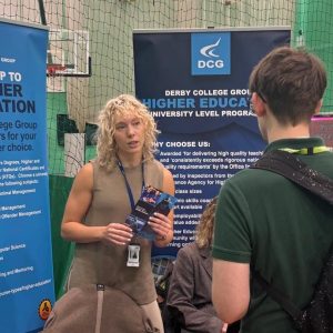 “Students speaking with a university representative at a higher education insight event, with banners promoting university level courses in animal care, equine studies and dog grooming, supporting progression into higher education.”